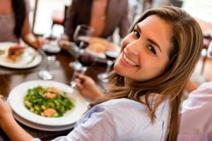 Happy woman having dinner at a restaurant